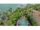 Aerial view of the property showcasing the enclosed pool and waterfront location at 1042 N Casey Key Rd, Osprey, FL 34229