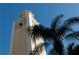 Ornate tower architecture with blue tile details, framed by lush palm trees and a clear blue sky at 1042 N Casey Key Rd, Osprey, FL 34229