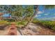 A walkway leading to a backyard with lush landscaping and waterfront views at 1042 N Casey Key Rd, Osprey, FL 34229