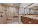 Modern bathroom featuring a glass enclosed shower, wooden seat, and a wood vanity with a stylish vessel sink at 1042 N Casey Key Rd, Osprey, FL 34229