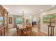 Formal dining room featuring a large wooden table, chandelier, and view of the living room at 1042 N Casey Key Rd, Osprey, FL 34229