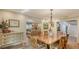Light-filled dining room with hardwood floors, chandelier, and access to the living room and stairs at 1042 N Casey Key Rd, Osprey, FL 34229