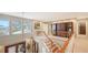 Stunning foyer with wood stairs, built-in cabinets, and large windows providing abundant natural light at 1042 N Casey Key Rd, Osprey, FL 34229