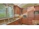 Kitchen with stainless steel appliances, granite countertops, and custom wood cabinetry at 1042 N Casey Key Rd, Osprey, FL 34229