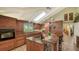 Lovely kitchen with a granite counter top, island, modern lighting, skylight, and tile flooring at 1042 N Casey Key Rd, Osprey, FL 34229