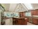 Bright, updated kitchen with an island, skylights, and an adjacent dining area with a view at 1042 N Casey Key Rd, Osprey, FL 34229