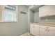 Bright laundry room offering ample cabinet space and a clean, functional layout with a window for natural light at 1042 N Casey Key Rd, Osprey, FL 34229