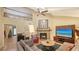 Spacious living room with fireplace, television, and view of the upstairs balcony at 1042 N Casey Key Rd, Osprey, FL 34229
