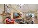 Bright living room with high ceilings, skylight, fireplace, and view of the pool at 1042 N Casey Key Rd, Osprey, FL 34229