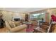 Inviting living room with a fireplace, piano, and comfortable seating arrangement at 1042 N Casey Key Rd, Osprey, FL 34229