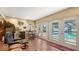 Relaxing indoor/outdoor living space with brick floors, a view of the pool, and cozy seating at 1042 N Casey Key Rd, Osprey, FL 34229