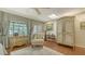Comfortable main bedroom with wood floors, skylight, sitting chair and view of the waterfront at 1042 N Casey Key Rd, Osprey, FL 34229