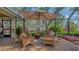 Comfortable outdoor seating on the patio, shaded by an umbrella with views of the surrounding landscape at 1042 N Casey Key Rd, Osprey, FL 34229