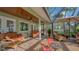 Inviting screened-in patio with comfortable seating and views of the surrounding landscape at 1042 N Casey Key Rd, Osprey, FL 34229