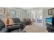 Comfortable sitting room with plush armchairs, decorative accents, and access to another room through glass doors at 1042 N Casey Key Rd, Osprey, FL 34229