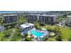 This stunning aerial view showcases the community pool, lush landscaping, and nearby lake at 1065 Gulf Of Mexico Dr # 103, Longboat Key, FL 34228