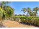 Lush backyard featuring views of the golf course and mature trees at 1065 Gulf Of Mexico Dr # 103, Longboat Key, FL 34228