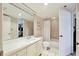 Bright bathroom featuring a single sink vanity and a shower-tub combo at 1065 Gulf Of Mexico Dr # 103, Longboat Key, FL 34228