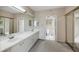 Bright bathroom featuring a double vanity and a separate water closet for added privacy at 1065 Gulf Of Mexico Dr # 103, Longboat Key, FL 34228