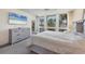 Comfortable bedroom offering lots of natural light and views with a relaxing seating area at 1065 Gulf Of Mexico Dr # 103, Longboat Key, FL 34228
