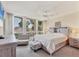 Inviting bedroom featuring many windows, neutral decor, and bright natural light at 1065 Gulf Of Mexico Dr # 103, Longboat Key, FL 34228