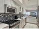Modern kitchen with stainless steel appliances, white cabinetry, and open access to the living area at 1065 Gulf Of Mexico Dr # 103, Longboat Key, FL 34228