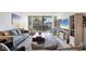 Cozy living room featuring modern decor, a large TV, and a view of the outdoor seating area on the balcony at 1065 Gulf Of Mexico Dr # 103, Longboat Key, FL 34228