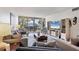 Spacious living room with a TV, comfortable seating, and a balcony view, providing a relaxing indoor-outdoor living experience at 1065 Gulf Of Mexico Dr # 103, Longboat Key, FL 34228