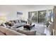 Bright living room with sliding glass doors to balcony and comfortable furnishings, perfect for relaxation and entertaining at 1065 Gulf Of Mexico Dr # 103, Longboat Key, FL 34228