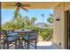 Cozy outdoor patio with a table and seating, offering a scenic view of a well-manicured yard at 1065 Gulf Of Mexico Dr # 103, Longboat Key, FL 34228