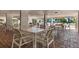 A covered outdoor patio with multiple tables and chairs, perfect for dining al fresco at 1065 Gulf Of Mexico Dr # 103, Longboat Key, FL 34228