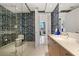 Stylish bathroom featuring a glass shower, patterned walls, and sleek vanity at 111 S Pineapple Ave # 716, Sarasota, FL 34236