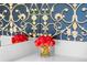Bathroom with patterned wallpaper, mirrored wall, decorative fresh flowers and accessories at 111 S Pineapple Ave # 716, Sarasota, FL 34236