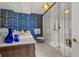 Elegant bathroom features a glass enclosed shower and a patterned accent wall at 111 S Pineapple Ave # 716, Sarasota, FL 34236