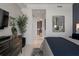 Modern bedroom with stylish decor leading into ensuite bathroom with patterned wall at 111 S Pineapple Ave # 716, Sarasota, FL 34236