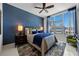 Modern bedroom with floor-to-ceiling windows showcases city views and a plush queen bed at 111 S Pineapple Ave # 716, Sarasota, FL 34236