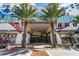 Modern condominium entrance with colorful mural, palm trees, and street access at 111 S Pineapple Ave # 716, Sarasota, FL 34236