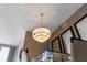 Looking up at the layered chandelier above a glass dining table and chairs at 111 S Pineapple Ave # 716, Sarasota, FL 34236