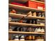 Organized closet shelves showcasing an array of shoes and accessories for neat storage at 111 S Pineapple Ave # 716, Sarasota, FL 34236