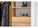 Stylish closet storage featuring hanging clothes, perfumes, and decorative accents at 111 S Pineapple Ave # 716, Sarasota, FL 34236