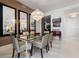 Bright dining room featuring a glass table, statement chandelier, and modern decor at 111 S Pineapple Ave # 716, Sarasota, FL 34236