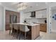 Modern kitchen featuring an island with seating, stainless steel appliances, and stylish light fixtures at 111 S Pineapple Ave # 716, Sarasota, FL 34236