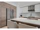 Kitchen featuring custom cabinets, an eat-in island, and stainless-steel appliances at 111 S Pineapple Ave # 716, Sarasota, FL 34236