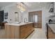 Modern kitchen with center island, stainless appliances, sleek wood cabinets, and marble floors at 111 S Pineapple Ave # 716, Sarasota, FL 34236