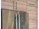 Close up on stainless refrigerator and custom cabinets with sleek modern pulls at 111 S Pineapple Ave # 716, Sarasota, FL 34236