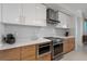 Bright kitchen boasts stainless steel appliances, modern white cabinets, and stylish wood-look lower cabinets at 111 S Pineapple Ave # 716, Sarasota, FL 34236