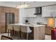 The kitchen features an island with seating, modern cabinetry, stainless steel appliances, and overhead lighting at 111 S Pineapple Ave # 716, Sarasota, FL 34236