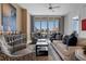 Bright and airy living room featuring a balcony with cityscape views, designer furniture, and modern decor at 111 S Pineapple Ave # 716, Sarasota, FL 34236