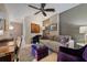 Inviting living room with a comfortable sofa, purple accent pieces, fan, and stylish decor at 111 S Pineapple Ave # 716, Sarasota, FL 34236