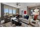Cozy living room with balcony access, comfortable seating, and a partial view into the dining room at 111 S Pineapple Ave # 716, Sarasota, FL 34236